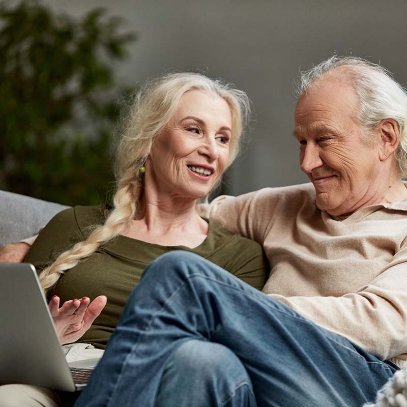 Happy smiling senior couple requesting service online