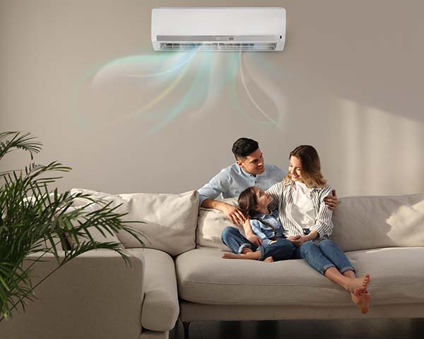 Family Resting Under Air Conditioner Heat Pump